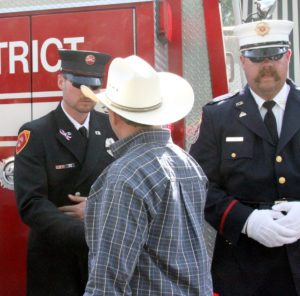 CLN's founder Patrick 'OD' O'Donnell shakes hands with a firefighter of the Central Yavapai Fire District in memory of the 19 Granite Mountain Hotshots in downtown Prescott, AZ