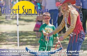 Jamie Stack shows Ethan Fritz how to pull in a roped Calf at the Gilbert Global Village Festival