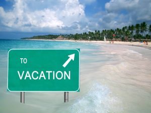 to-vacation-sign-in-the-caribbean-ocean-with-arrow-pointing-at-a-tropical-beach