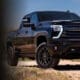 Black 2026 Chevy Silverado HD on a desert trail beside The Hondo Rodeo Fest logo, presented by Chevrolet and Valley Chevy Dealers, November 13-15 at Chase Field in Phoenix