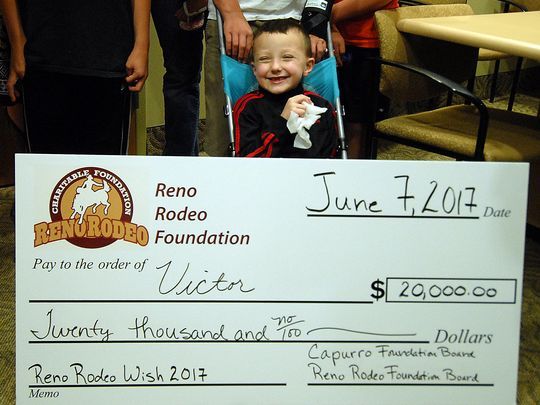 A very happy Victor Sciarrotta, age 6, sits behind a huge $20,000 check his family received from Reno Rodeo Foundation at St. Marys Health Center Friday June 9, 2017. Photo by Marilyn Newton for the Reno Rodeo Foundation