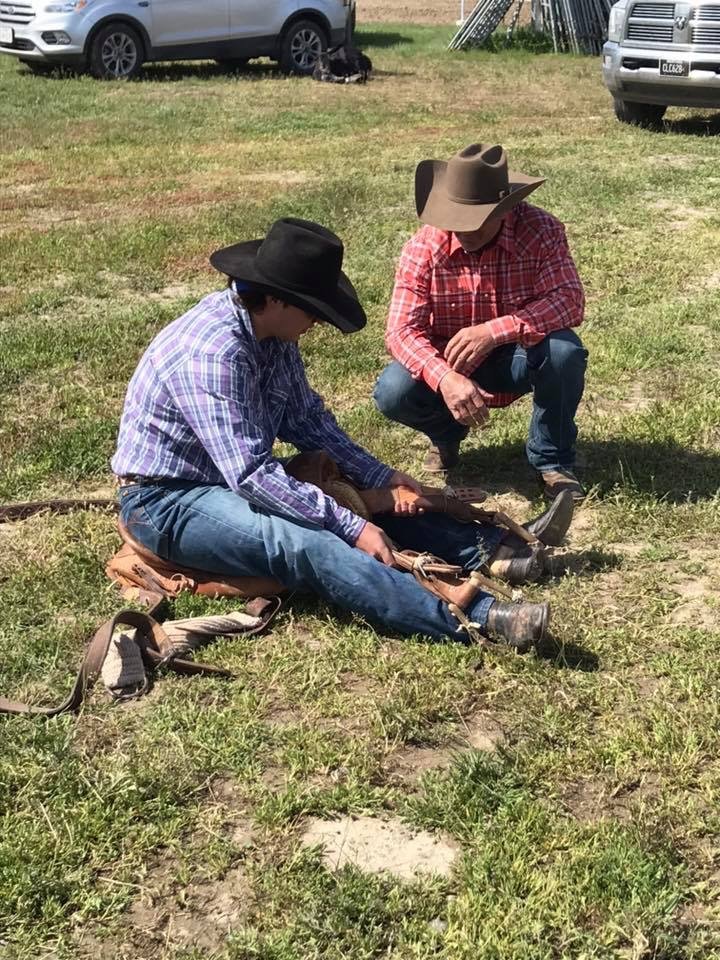 Past PRCA bronc riding champion Tom Reeves helps a student find his form. Building Champions Photo