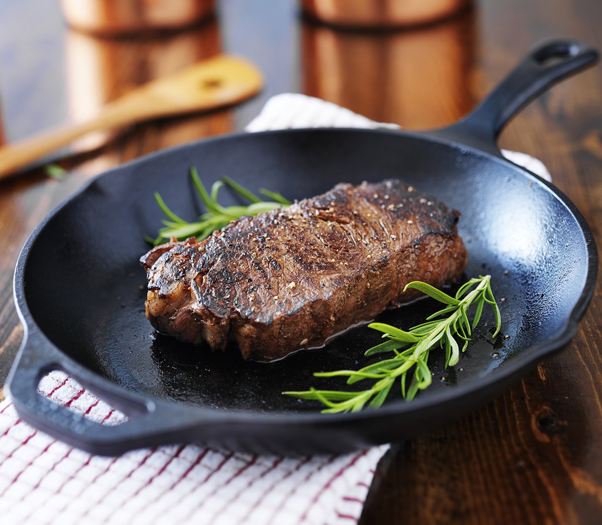 new york strip steak cooked in iron skillet