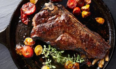 top down photo of a new york strip steak on iron skillet