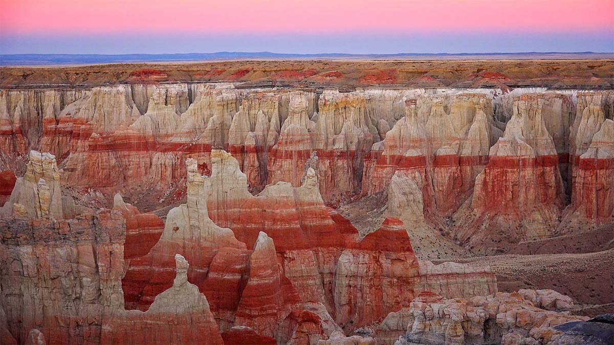 Pink light of twilight in the sky at coal mine canyon in Tuba City, Arizona
