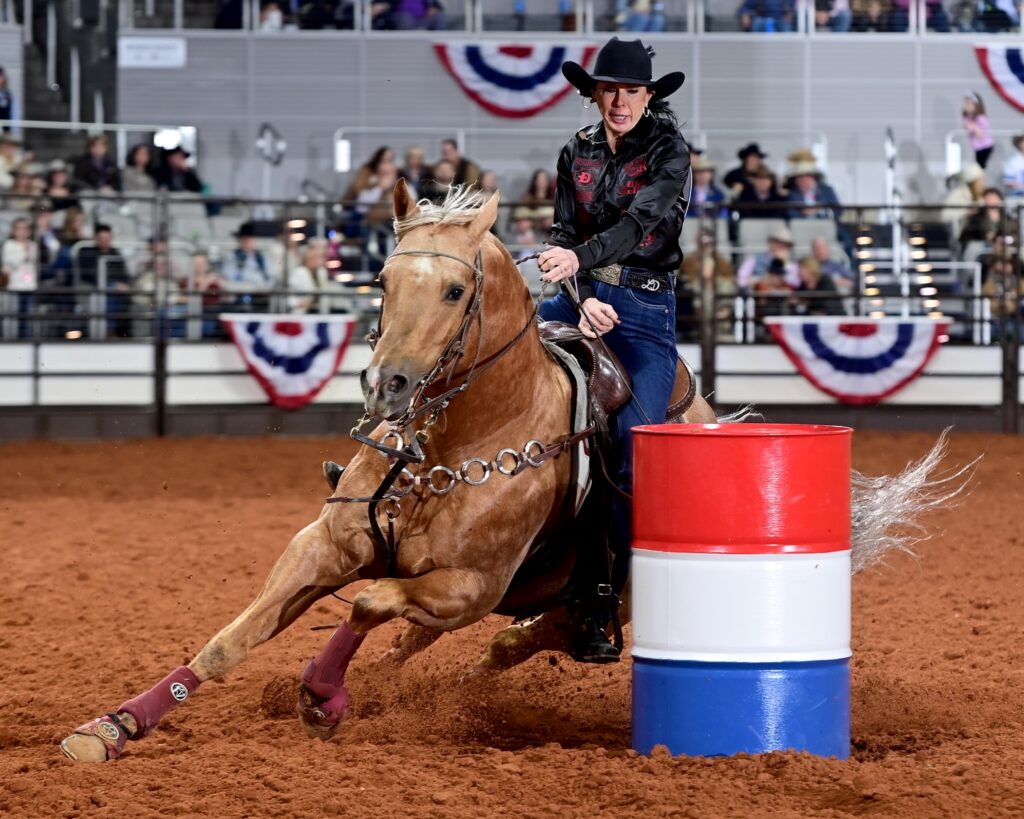 LaTricia Duke of Zephyr, Texas, and her stud Vanilla Wafer (DM High Roller) won the opening round of Bracket 1 at the Fort Worth Stock Show & Rodeo’s ProRodeo Tournament when they finished the barrel racing pattern in 16.40 seconds. FWSSR photo by James Phifer
