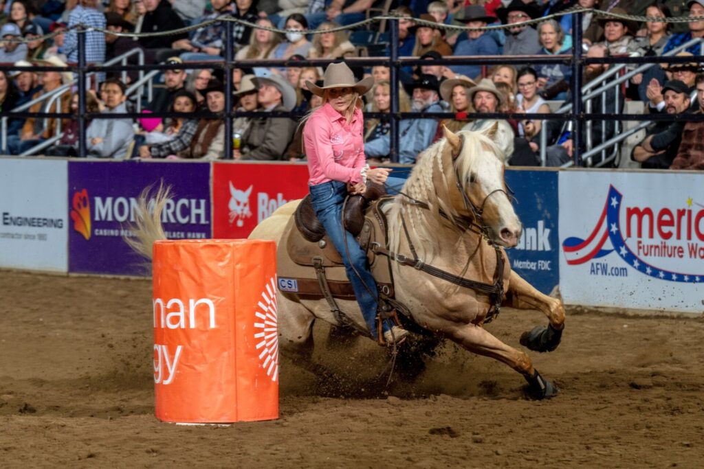 Carlee Otero of Perrin, Texas, who is still recovering from breaking her pelvis in December, outraced the field to win the barrel racing championship at the National Western Stock Show Rodeo. Otero and her horse Blingolena (Sly) were the final competitors and finished the course in 14.71 seconds. NWSS photo by Ric Andersen