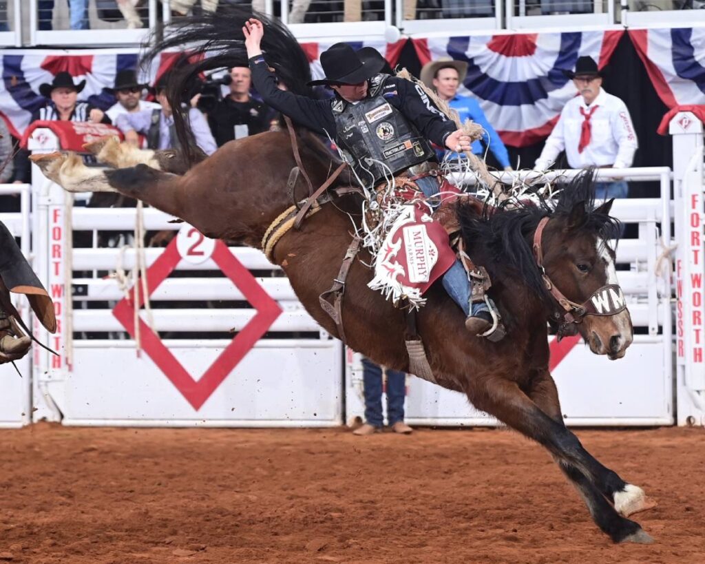 There was a big Canadian matchup in the saddle bronc riding in round one of Bracket 7 at the Fort Worth Stock Show & Rodeo’s ProRodeo Tournament on Monday. That match between Layton Green of Millarville, Alberta, and Mary Jane, owned by Macza Pro Rodeo of High River, Alberta, resulted in a round-winning 86 points. FWSSR photo by James Phifer.