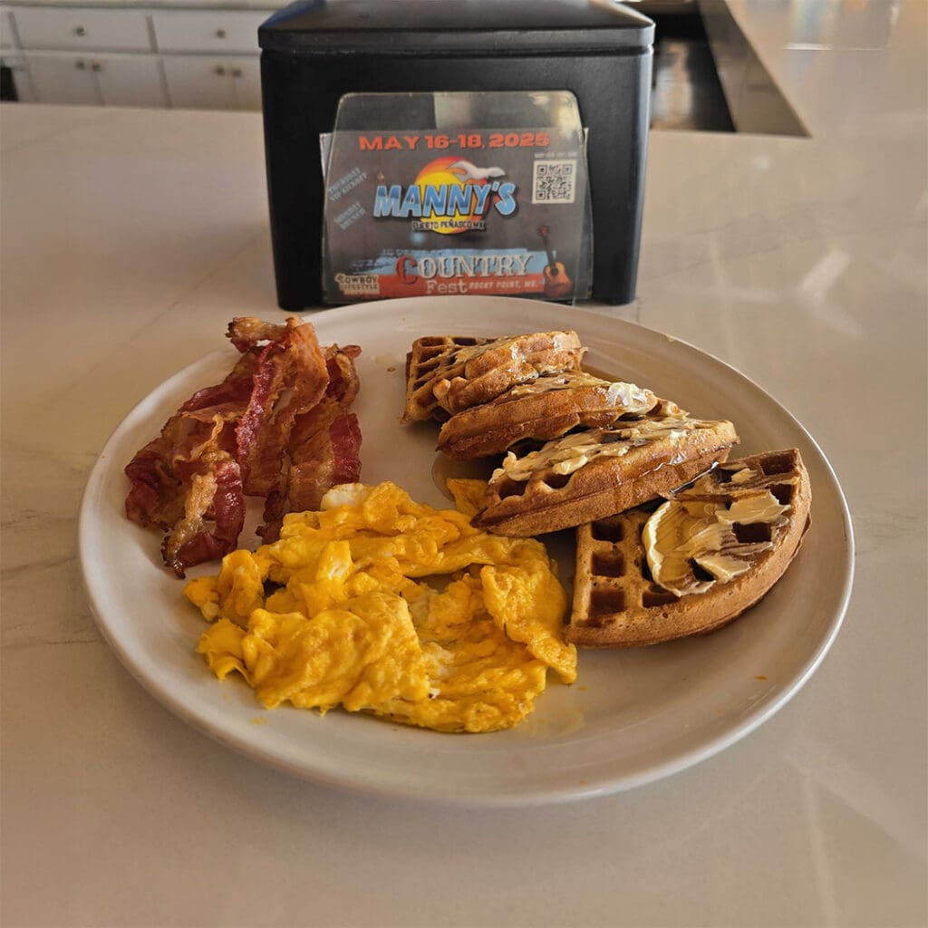 At Mannyโs Beach Club, you can have waffles and two eggs cooked your way, served with bacon or ham, for only $10.