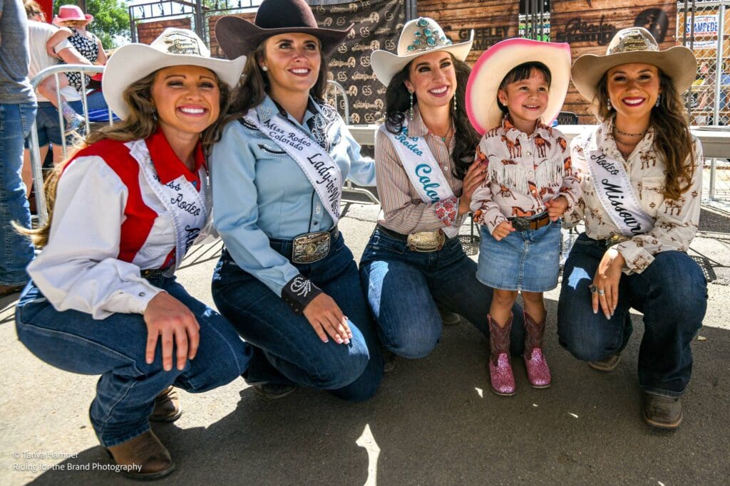 Rodeo queens a little cowgirl smiling for a photo