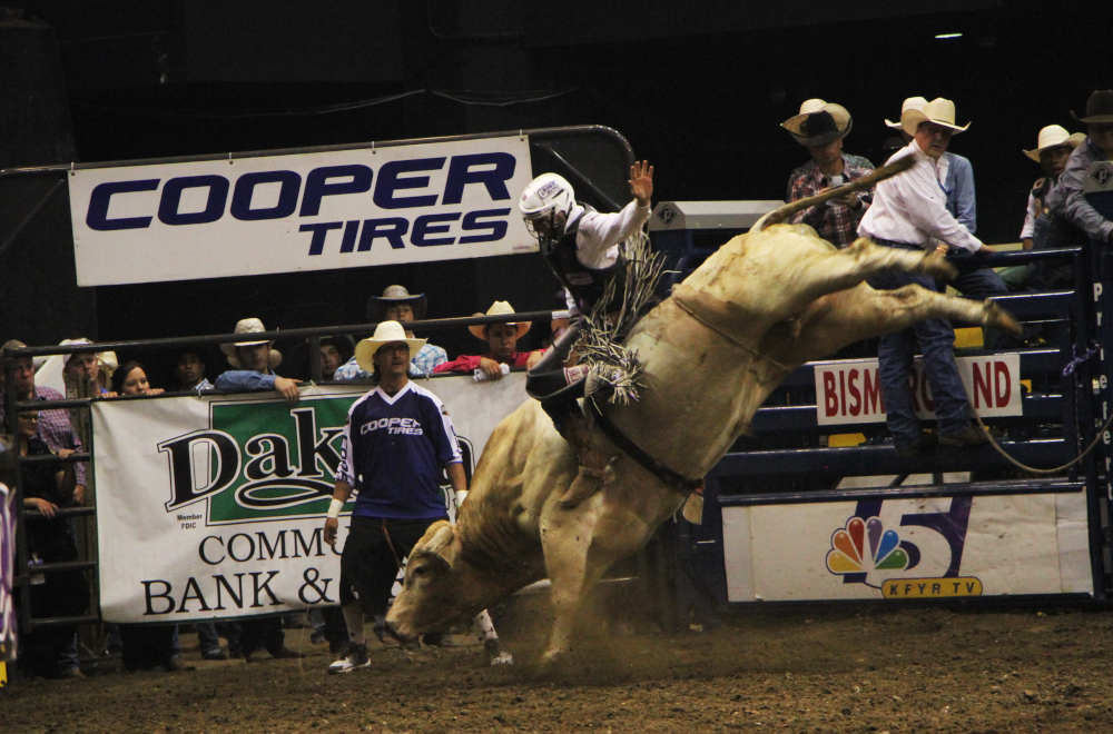 Bull rider competing at Dakota PBR Challenge