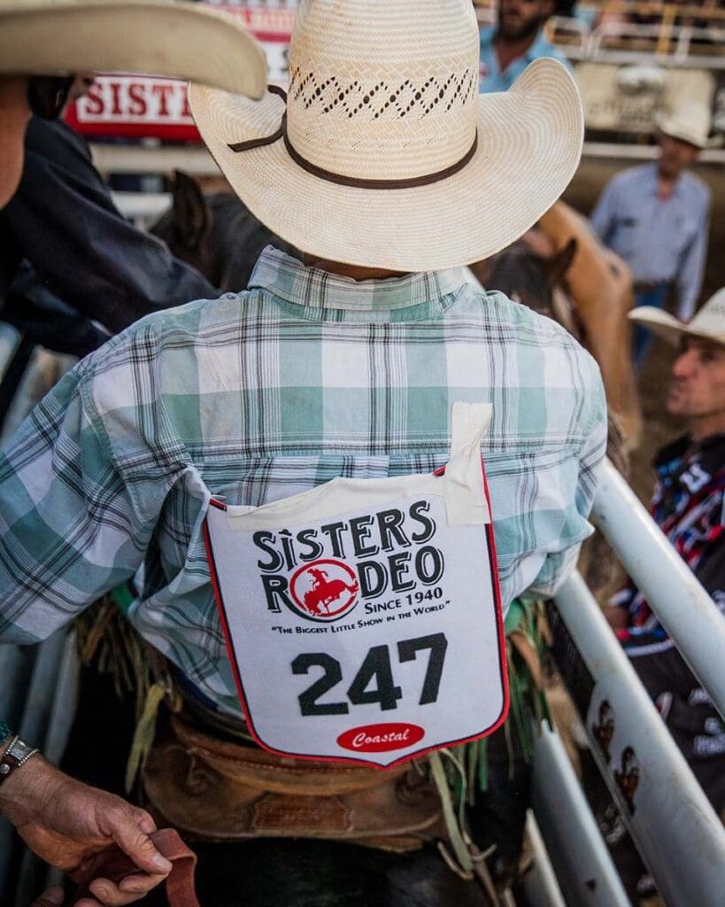 Cowboy in the chutes on saddle bronch at Sisters Rodeo. Photo credit: Sisters Rodeo