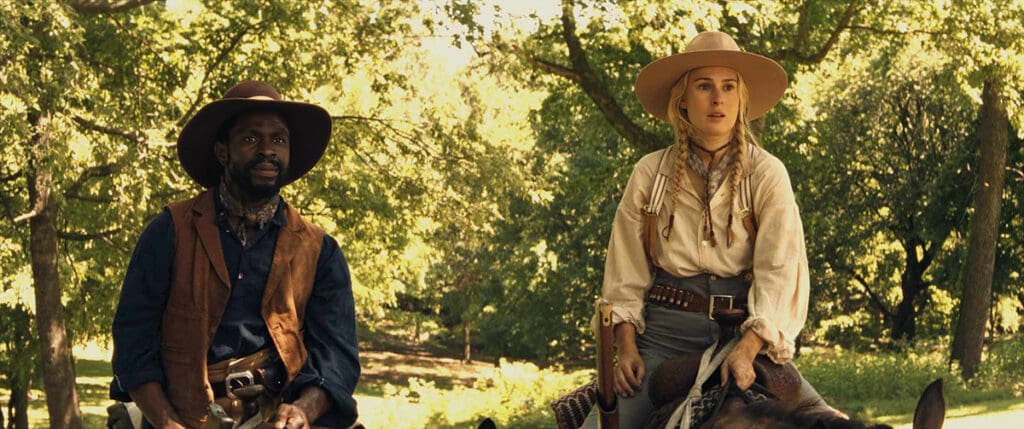 John Scobell (Gbenga Akinnagbe) & Katherine Atherton (Rumer Willis) in Trail of Vengeance (2025)