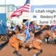Woman riding a horse with flag held high. UHSRA