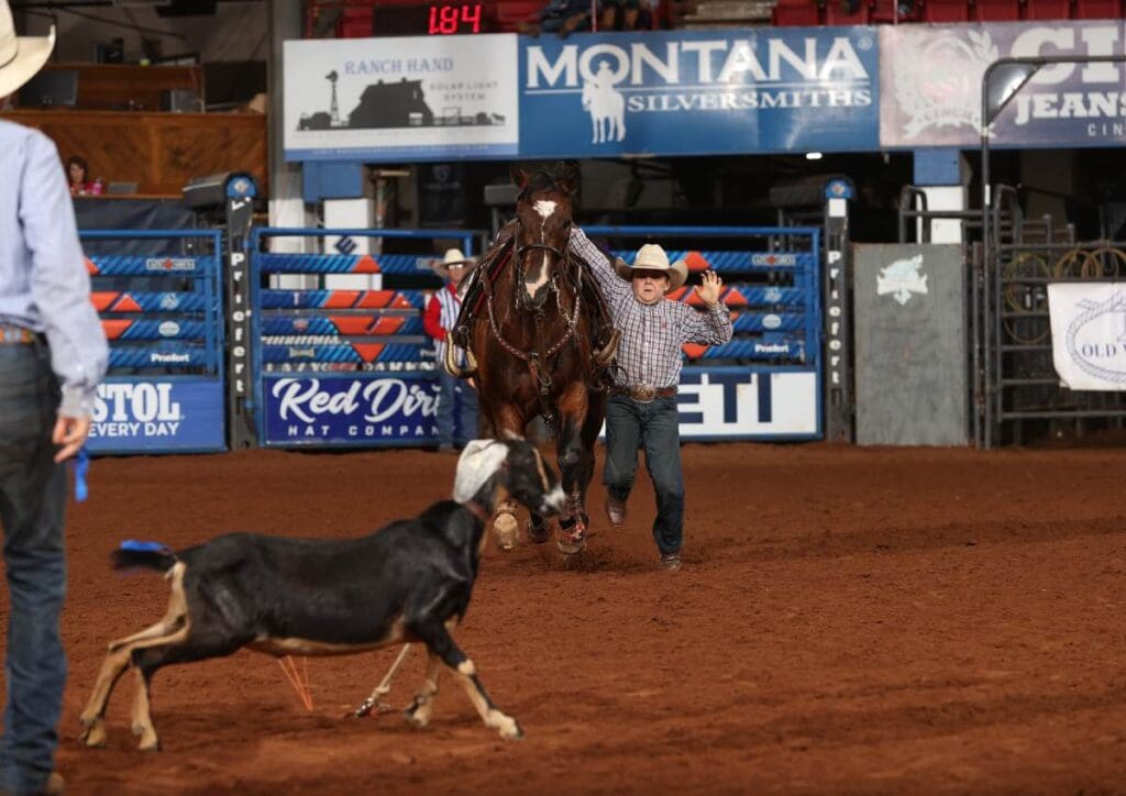 National Little Britches goat tyer getting off his horse