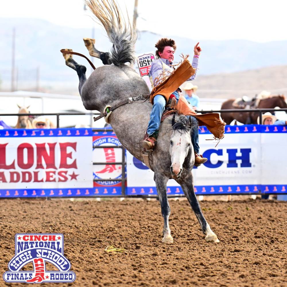 Saddle bronc rider hanging on for 8 seconds at National High School Finals Rodeo