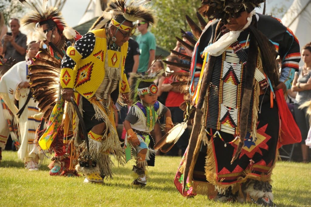 Performers wearing traditional Native American outfits