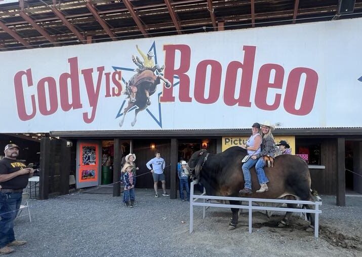 2 girls on bull named Norman
