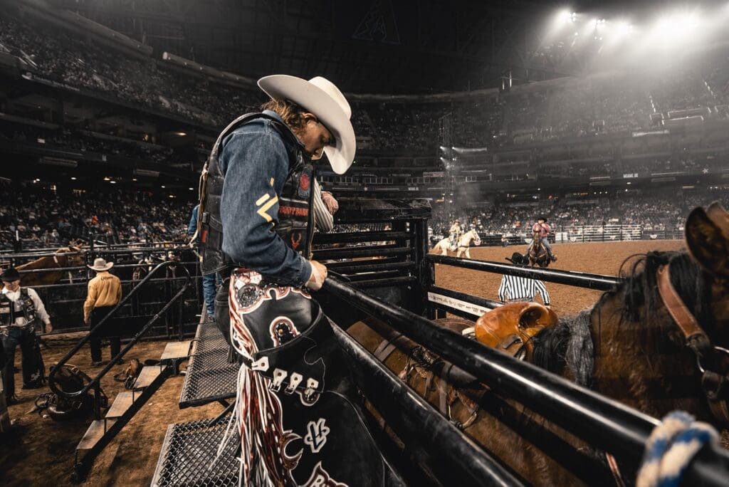 Bronc rider behind bucking chute at Hondo Rodeo Fest