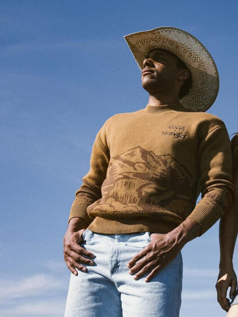 Man with a Wrangler Coors Sweater that features the Rocky Mountains