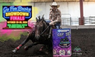 Cowgirl riding a horse around a barrel