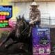 Cowgirl riding a horse around a barrel