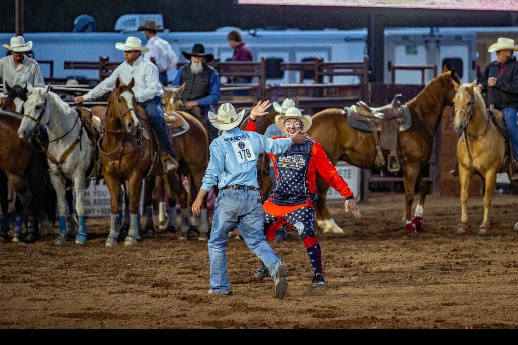 Cowboy high-fiving a rodeo clown