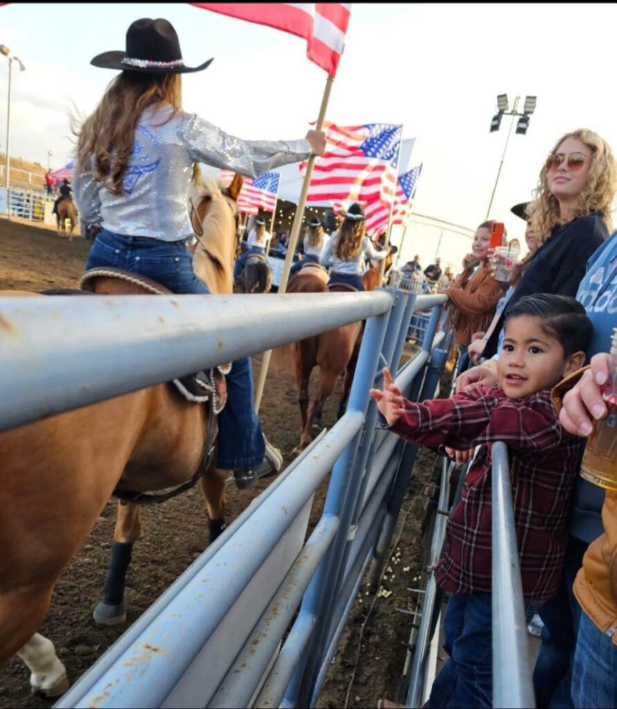 Flag girls riding around the arena. Photo from Santa Maria Elks Rodeo _ Parade FB