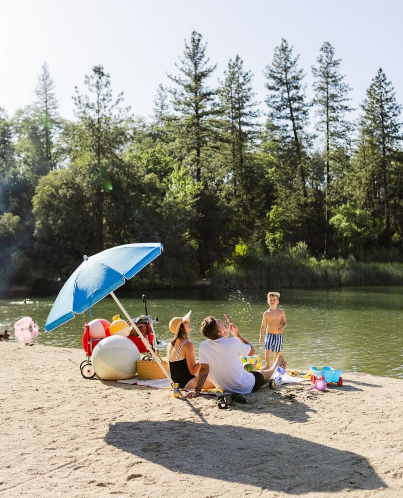 Family on the beach at a lake in Redding California