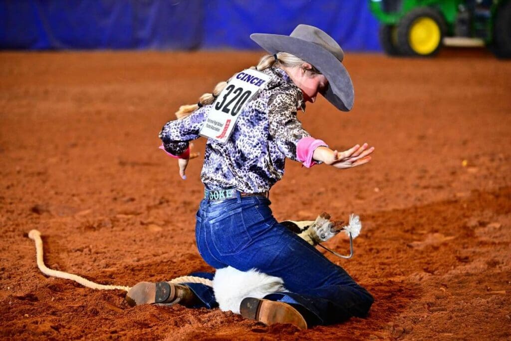 Goat tying by young cowgirl.