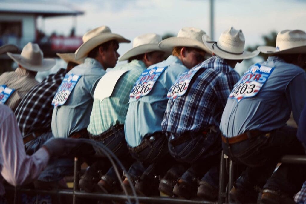 Riders with their back pin numbers displayed  lined up on the back chutes at International finals. Photo Courtesy of 870 Sports Photography