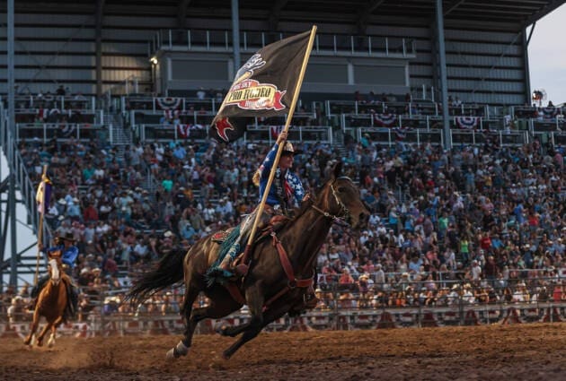 Presenting the rodeo flag on horseback. 2024 Great Falls Perf 4. Photo by HRae