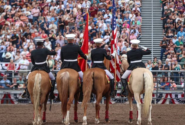 Presentation of the American Flag by Miliary Personnel on horseback.