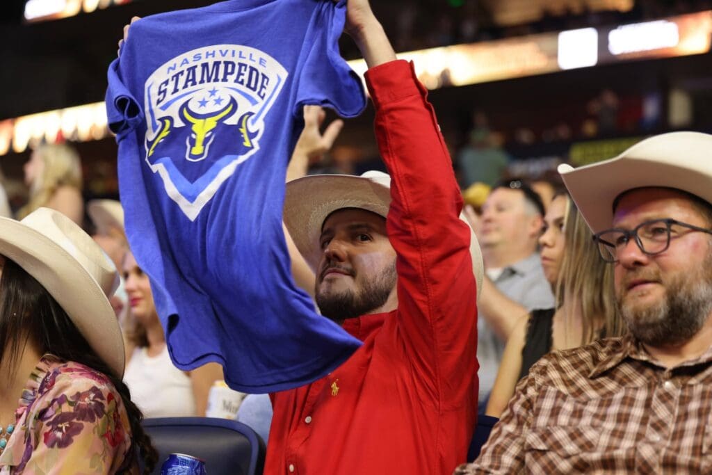 Fan holding Nashville Stampede shirt