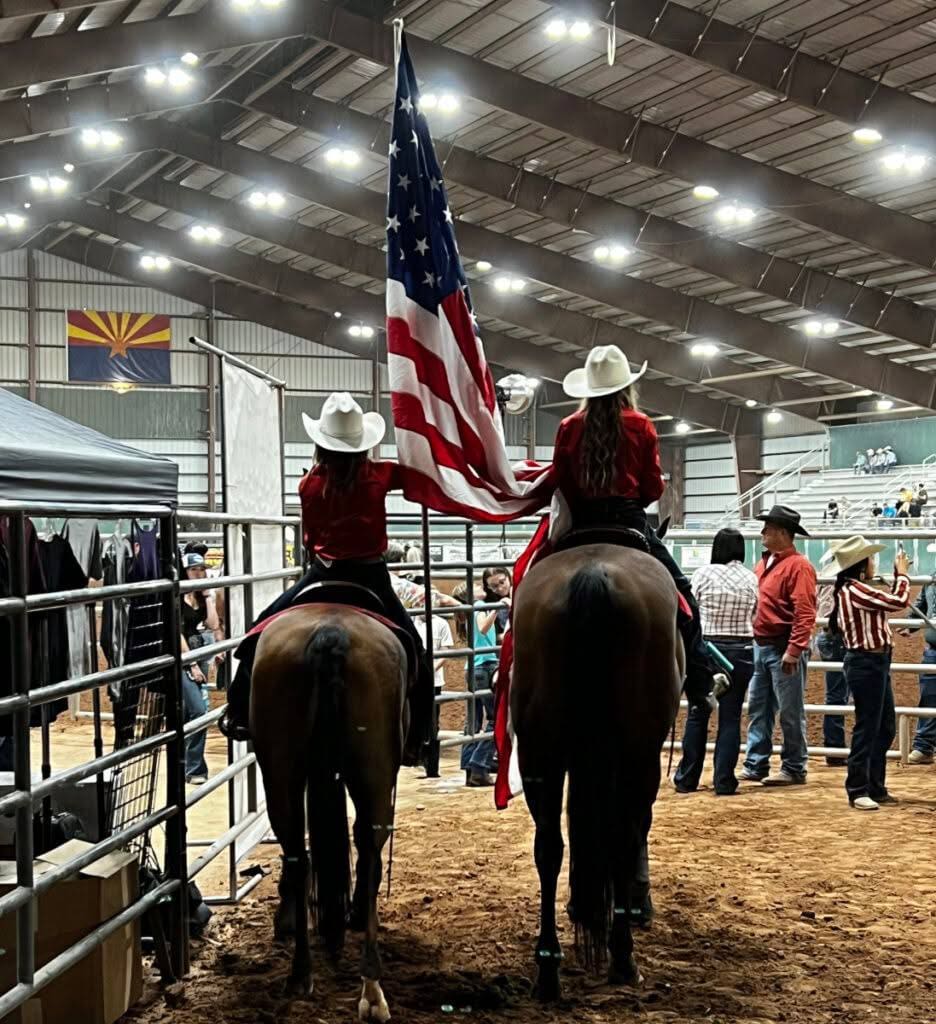 American Flag being carried by 2 cowgirls on horseback. Photo from Creek Bash Rodeo 2025 FB.