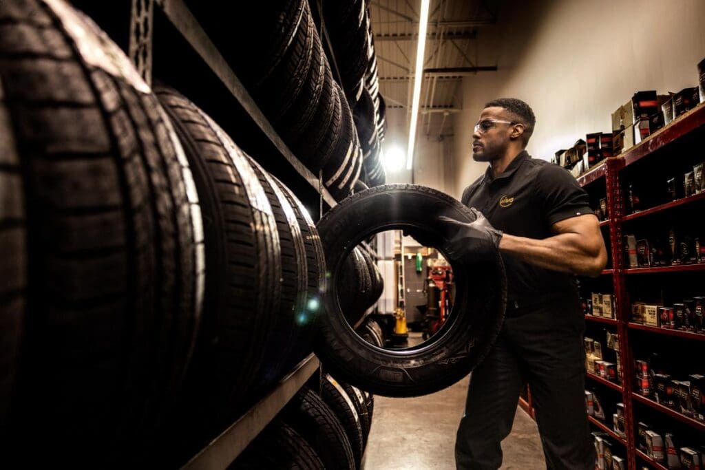 Tech Pulling Tire at Midas 26